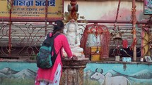 Hindu woman worshiping a Hindu idol at the Taraknath Temple in Kolkata, India.