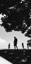 silhouettes of a father and his children 