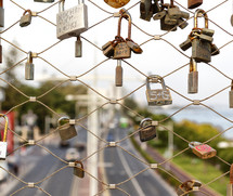 love locks on a fence overlooking a highway 