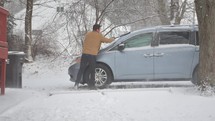 Man scraping ice from car
