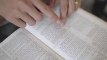 Hand of man reading the Bible Spiritual concepts by studying the Holy Scriptures together.
