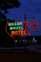 wagon wheel motel neon sign at night 