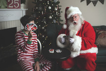 A boy and Santa playing UNO 