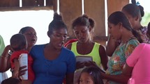 Woman singing in small church service in Honduras
