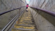 a boy running up stairs 