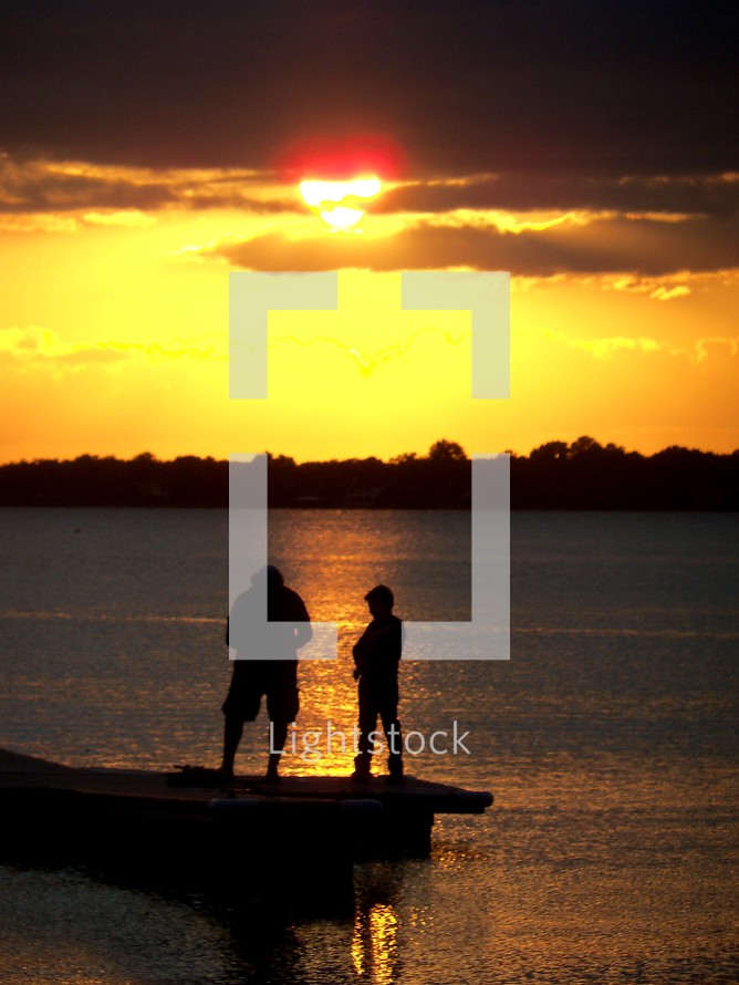 silhouettes of fishermen at sunset 