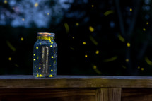 lightning bugs glowing in a jar at night