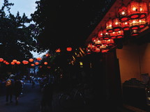 lanterns over a street at night 