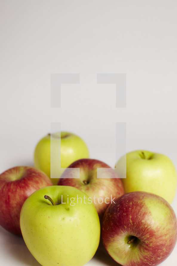 A group of green and red apples isolated on white.