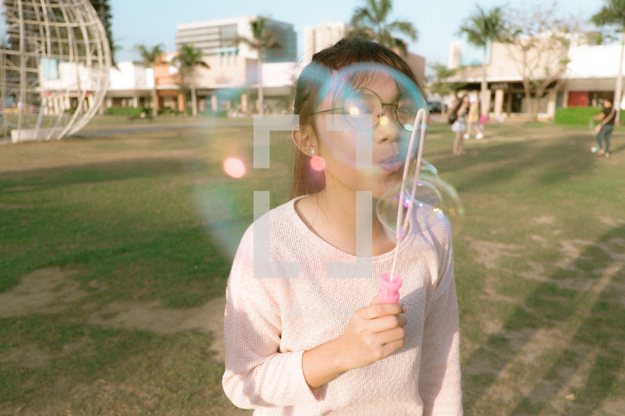 girl blowing bubbles 