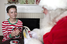 a teen and Santa playing Uno cards together 