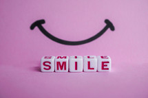 smile word on the pink background, feelings and emotions