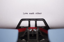 words love each other typed on a typewriter 