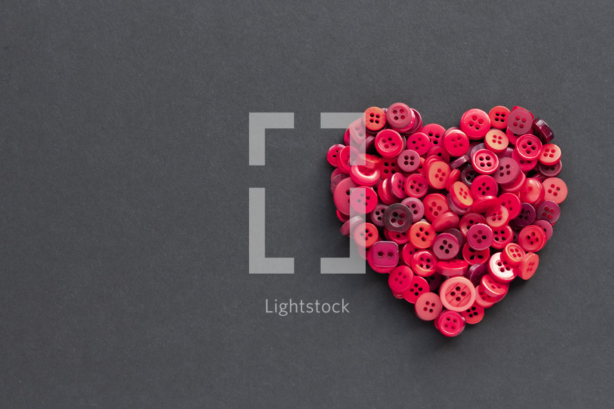 red heart of buttons on a black background 