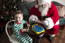 a boy playing with toys with Santa 