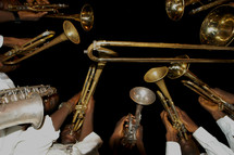 musicians playing trumpets, saxophones, and trombones