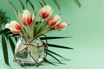 vase of tulips and palm fronds 
