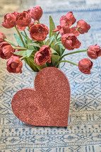 vase of tulips and red heart 