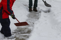 a father and son shoveling snow
