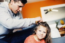 father braiding hair 