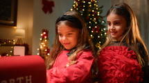 Happy young girls giving their wishes to santa