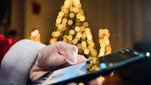 Santa Claus scrolling with smartphone on social media