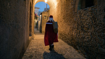 Santa Claus around a village on Christmas night