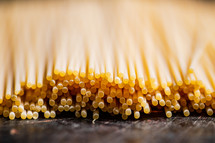 A pile of spaghetti dry on the table. Against a dark background. High quality photo