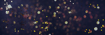 Golden shiny glitter, sparkles, light bokeh on dark background. New year, Christmas background. Banner with copy space. Festive backdrop for greeting card