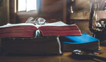 reading glasses and magnifying glass with Bibles 