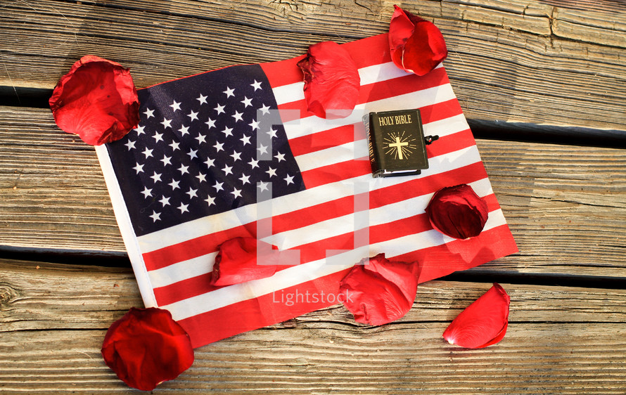 Bible and rose petals on an American flag 