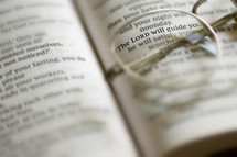 Hope concept. Closeup Reading Glasses On Open Bible