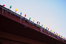 Christmas lights and icicles on a gutter