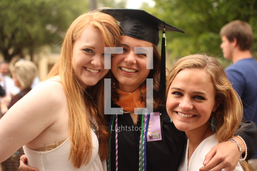 friends hugging at graduation