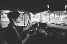 Teenager driving a classic car