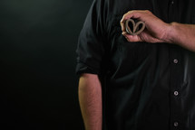 a man holding a roll of cash in the shape of a heart