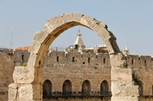 Walls of old city Jerusalem and stone arch 