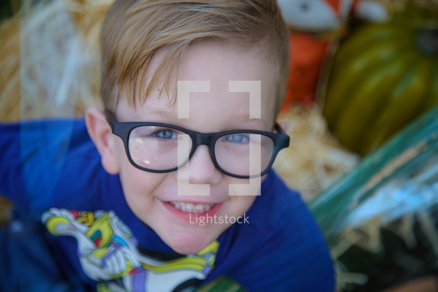 a smiling boy in glasses 