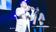 a man singing into a microphone 