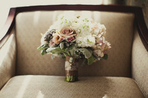 A bouquet of flowers sitting in a chair
