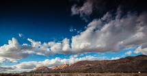 clouds and a cobalt blue sky over mountains in Nevada 