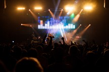 singer on stage at a concert under stage lights