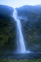 A beautiful waterfall pouring down a mountainside