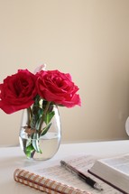 roses in a vase and notebook and Bible 