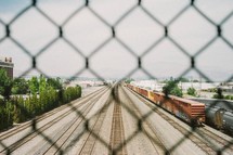 chain link fence and train and tracks 
