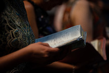 parishioners holding Bibles during a worship service 