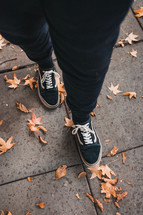 woman standing on a sidewalk in fall 