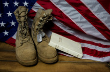Holy Bible, American flag, boots, and military dog tags