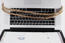 rope around a laptop computer 
