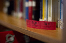 raffle tickets on a library  bookshelf 